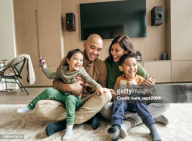 happy family at home on winter holidays - family at home stock pictures, royalty-free photos & images