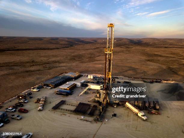 fracking drilling rig at dusk or dawn - fracking stock pictures, royalty-free photos & images