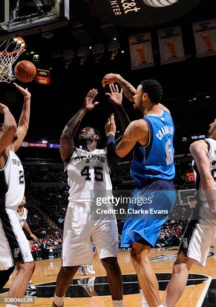 Tyson Chandler of the Dallas Mavericks passes over Tim Duncan and DeJuan Blair of the San Antonio Spurs during the game on January 14, 2011 at the...