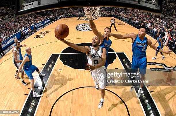 Tony Parker of the San Antonio Spurs shoots a layup against Tyson Chandler of the Dallas Mavericks during the game on January 14, 2011 at the AT&T...