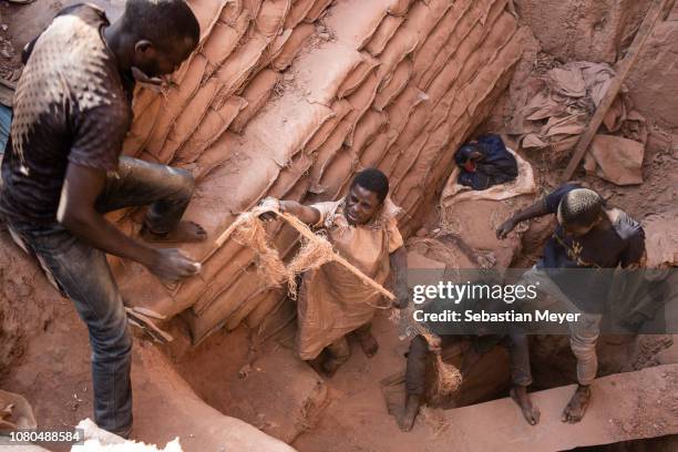 Miners pull up a bag of cobalt their colleague is digging underground inside the CDM Kasulo mine. "n"nCobalt is a vital mineral needed for the...