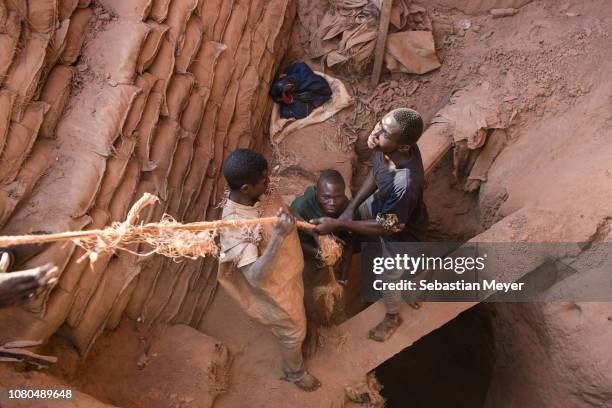 Miners pull up a bag of cobalt their colleague is digging underground inside the CDM Kasulo mine. "n"nCobalt is a vital mineral needed for the...