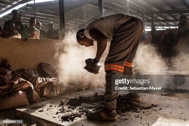 Miner crushes cobalt that will be tested for purity at the depot at the CDM Kasulo mine. "n"nCobalt is a vital mineral needed for the production of...