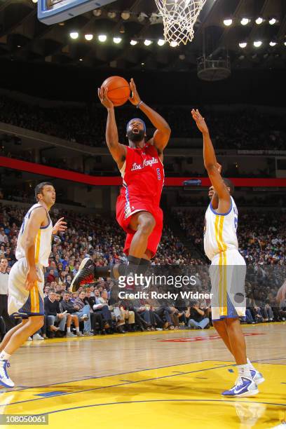 Baron Davis of the Los Angeles Clippers drives the ball against Reggie Williams of the Golden State Warriors on January 14, 2011 at Oracle Arena in...