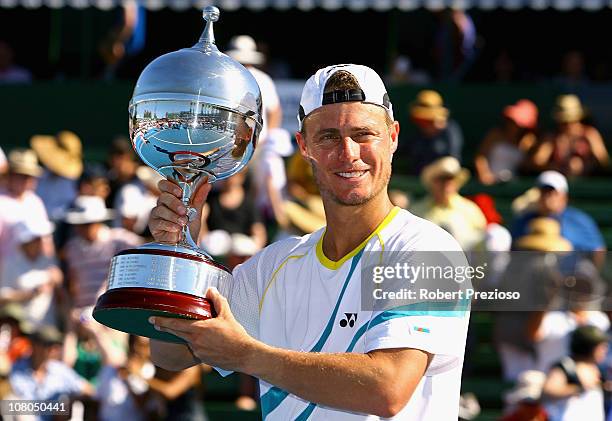 Lleyton Hewitt of Australia holds aloft the winners trophy after winning his match against Gael Monfils of France during day four of the AAMI Classic...
