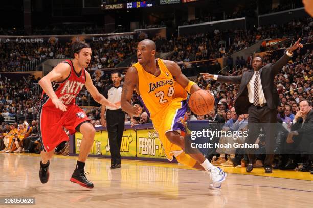 Kobe Bryant of the Los Angeles Lakers goes to the basket against Sasha Vujacic of the New Jersey Nets at Staples Center on January 14, 2011 in Los...