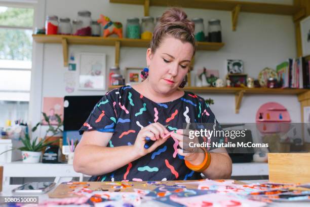 Mature adult female small business owner and designer working in studio office