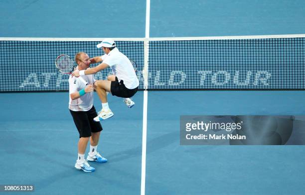 Paul Hanley of Australia jumps on team mate Lukas Dlouhy of the Czech Republic after winning the Mens doubles final against Bob and Mike Bryan of the...