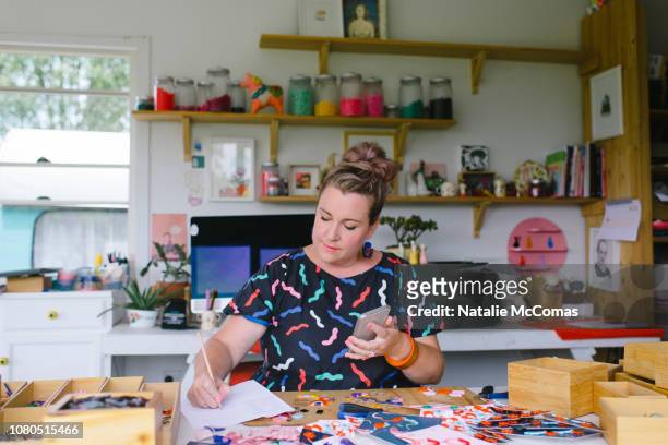 Mature adult female small business owner and designer working in studio office
