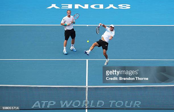 Paul Hanley of Australia and Lukas Dlouhy of the Czech Republic volley in their Mens doubles final against Bob and Mike Bryan of the USA during day...