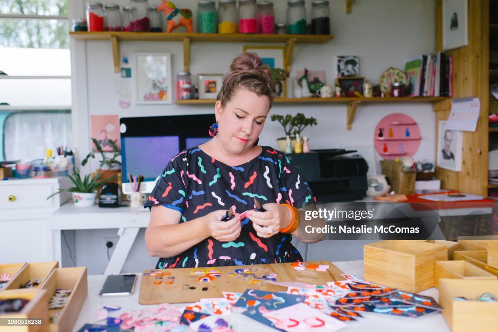 Mature adult female small business owner and designer working in studio office