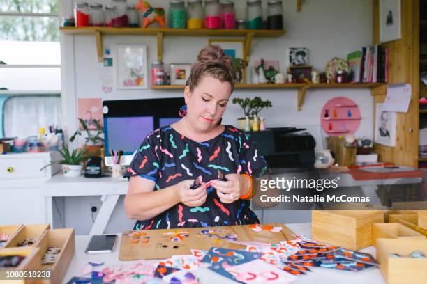 Mature adult female small business owner and designer working in studio office