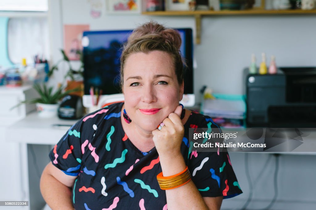 Mature adult female small business owner and designer working in studio office