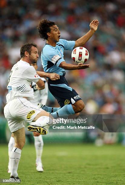 Nick Carle of Sydney is challenged by Grant Brebner of Victory during the round 23 A-League match between Sydney FC and the Melbourne Victory at...