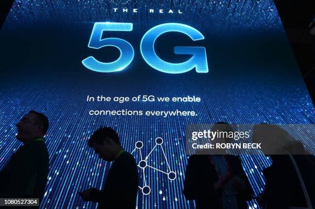 Attendees wait in line for a 5G exhibition at the Qualcomm booth during CES 2019 consumer electronics show, on January 10, 2019 at the Las Vegas...