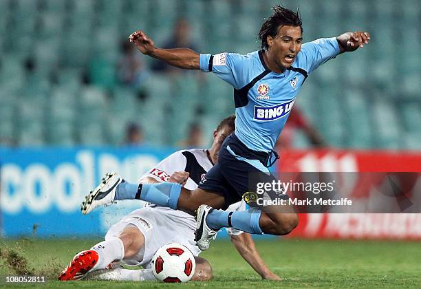 Nick Carle of Sydney is tackled by Danny Allsopp of Victory during the round 23 A-League match between Sydney FC and the Melbourne Victory at Sydney...