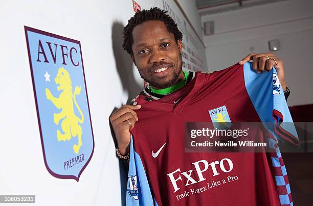 Jean Makoun holds up his shirt after announcing signing with Aston Villa at the Aston Villa training ground Bodymoor Heath on January 15, 2011 in...