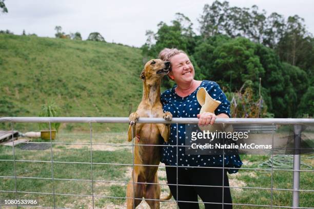 Portrait of mature woman laughing on a rural property with dog