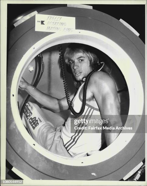 Sydney swans full forward Warwick Capper with the new &amp; 100,000 Divetech International Recompresion chamber at the Sydney Hilton. March 02, 1987....