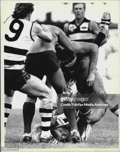 Swan full forward Warwick Capper cringes on the ground as a gee long player follows through with appears to be a right hand punch. June 29, 1986. .