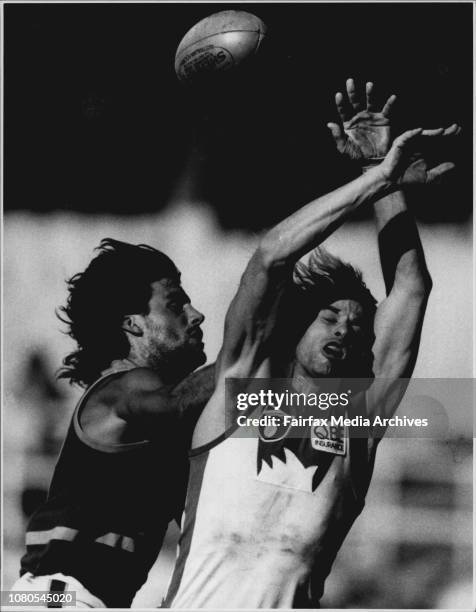 Warwick Capper flies high between two Brisbane defenders in the game at the S.C.G. Swans V'S bears at the S.C.G. June 02, 1991. .
