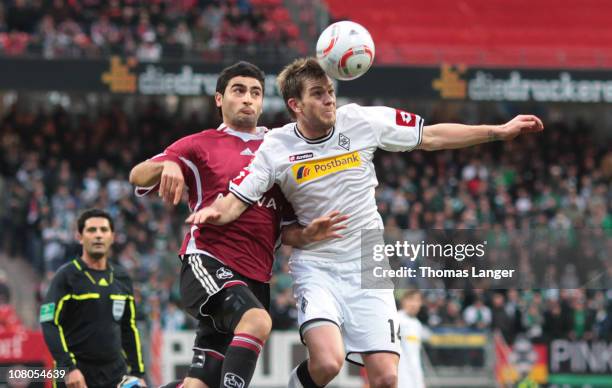 Thorben Marx and Mehmet Ekici of Nuremberg battle for the ball during the Bundesliga match between 1. FC Nuernberg and Borussia Moenchengladbach at...