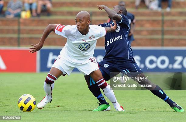 Vuyo Mere of the Swallows is challenged by Sifiso Myeni of Bidvest Wits during the Absa Premiership match between Bidvest Wits and Moroka Swallows at...