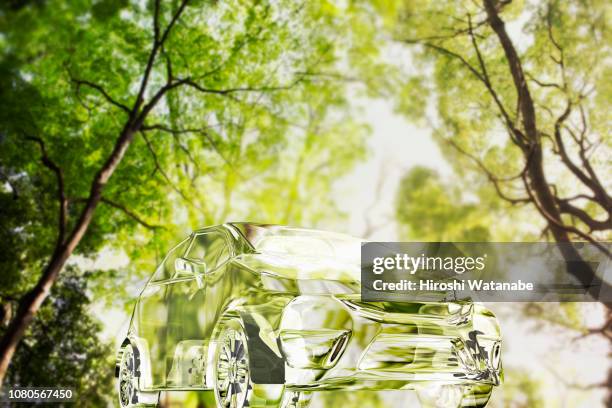 image of renewable energy. transparent car in the forest. - car nature ストックフォトと画像