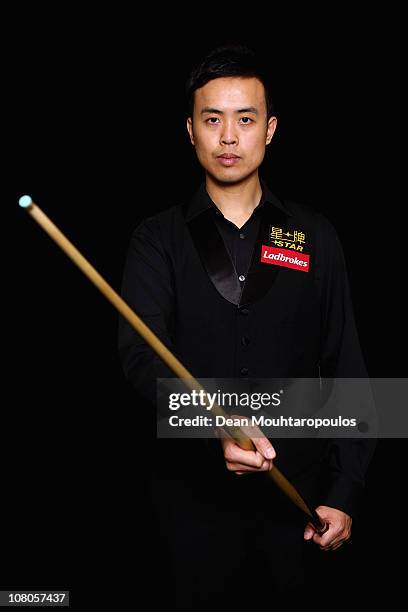 Marco Fu of Hong Kong poses for a photo after his victory against Mark Allen of Northern Ireland in the semi final of The Ladbrokesmobile Masters on...