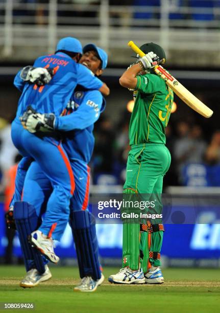 Piyush Chawla and Mahendra Singh Dhoni celebrate as Wayne Parnell of South Africa reacts after losing his wicket to give India victory during the 2nd...