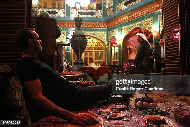 Australian goalkeeper Mark Schwarzer enjoys dinner at a local restaurant in the Souq Waqif on January 15, 2011 in Doha, Qatar. The Australian squad...