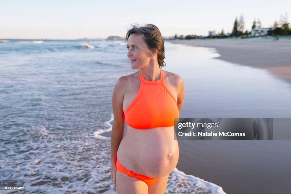 Portrait of mature pregnant woman on beach