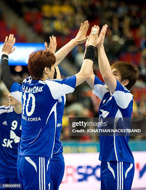 Korea's Dong Geun Yu celebrates with teammate Chan Yong Park after their victory during the 2011 Men's Handball World Championships group D match...