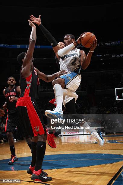 John Wall of the Washington Wizards shoots against Amir Johnson of the Toronto Raptors at the Verizon Center on January 15, 2011 in Washington, DC....