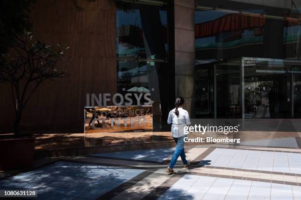 An employee walks past the Infosys Experience Center at the Infosys Ltd. Campus in the Electronics City information technology hub in Bengaluru,...