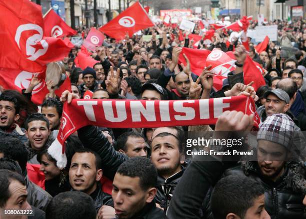 Tunisian expatriates shout slogans while holding Tunisian flags as they demonstrate on January 15, 2011 in Paris, France. Zine al-Abidine Ben Ali,...