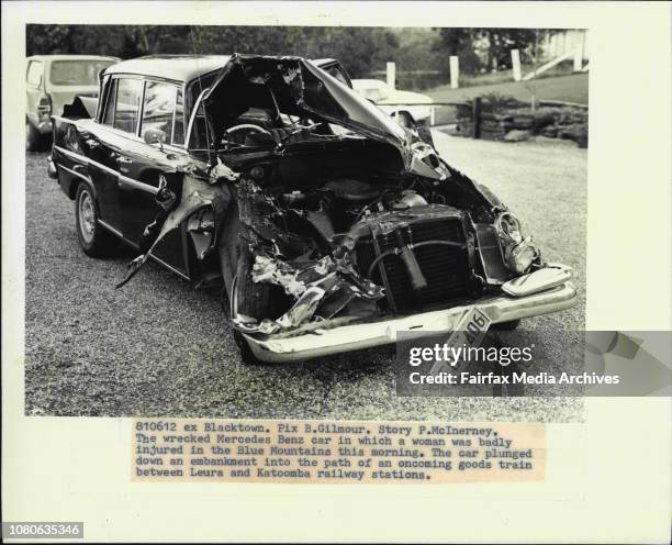 The wrecked Mercedes Benz car in which a woman was badly injured in the Blue Mountains this morning. The car plunged down an embankment into the path...