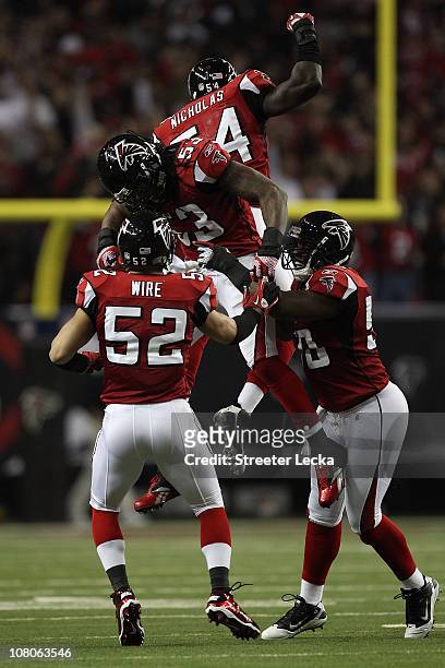 Coy Wire, Mike Peterson, Stephen Nicholas and Curtis Lofton of the Atlanta Falcons celebrate a defensive play against the Green Bay Packers during...