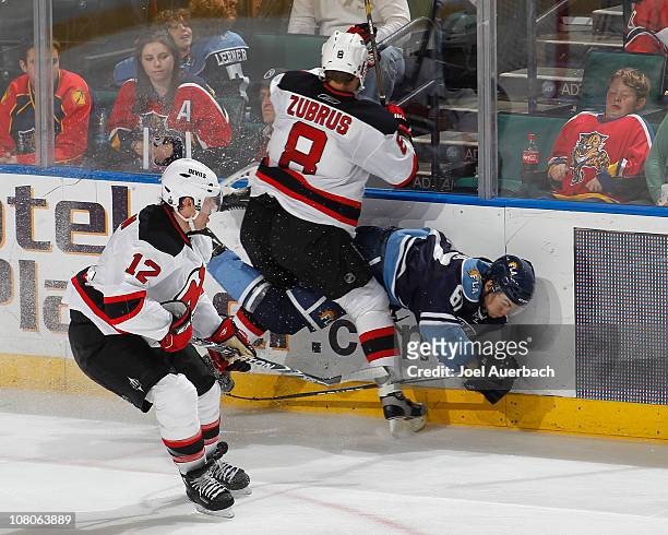 Brian Rolston watches as Dainius Zubrus of the New Jersey Devils checks Michael Frolik of the Florida Panthers on January 15, 2011 at the...