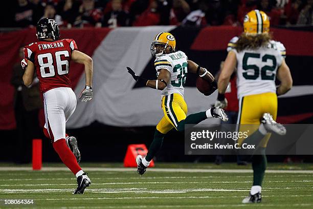 Tramon Williams ##8 of the Green Bay Packers returns an interception 70-yards for a touchdown in the second quarter against the Atlanta Falcons...