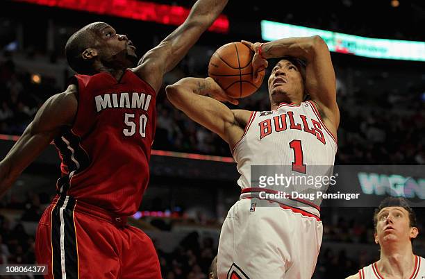 Derrick Rose of the Chicago Bulls gets off a shot as he is fouled by Joel Anthony of the Miami Heat at the United Center on January 15, 2011 in...