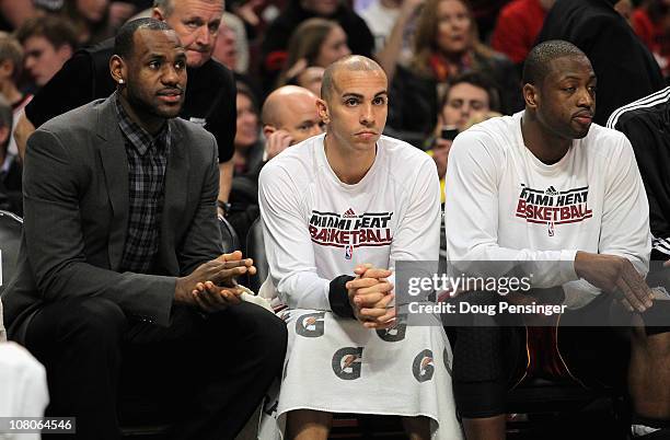 LeBron James, Carlos Arroyo and Dwyane Wade of the Miami Heat sit on the bench in the fourth quarter against the Chicago Bulls at the United Center...