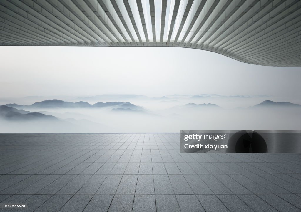 Empty pavement with misty mountains