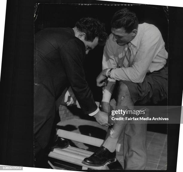 Acting League Medical Officer, examines Norm Provan's injured left leg.Acting Rugby League medical officer examines Norm Provan's injured left leg at...