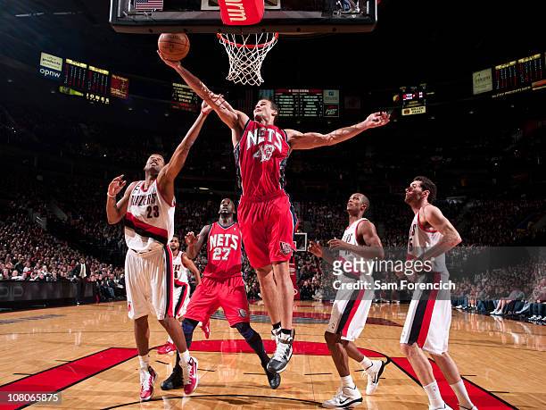 Kris Humphries of the New Jersey Nets goes up for a shot against Marcus Camby of the Portland Trail Blazers during a game on January 15, 2011 at the...