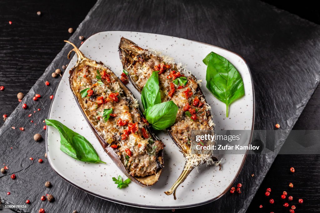 Portuguese cuisine. Baked eggplants with mushrooms, meat, vegetables and parmesan cheese. Copy space, selective focus