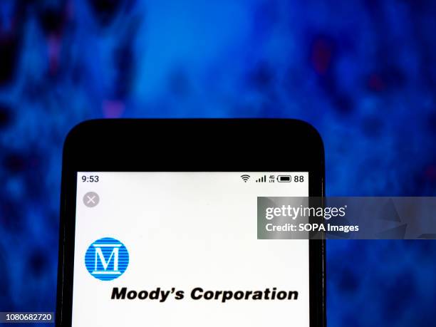 In this photo illustration, the Moody's Corporation Financial services company logo seen displayed on a smartphone.