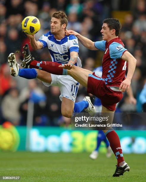 David Bentley of Birmingham City battles with Ciaran Clark of Aston Villa during the Barclays Premier League match between Birmingham City and Aston...