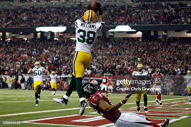 Tramon Williams of the Green Bay Packers intercepts a pass in the endzone against Michael Jenkins of the Atlanta Falcons during their 2011 NFC...