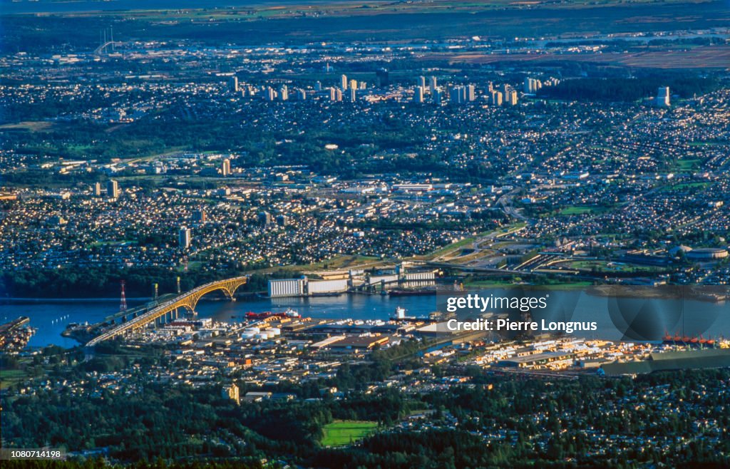 High angle view of Burrard Inlet with the Second Narrows Bridge also called Ironworkers Memorial Bridge. North Vancouver in foreground, Burnaby and New Westminster in backdrop